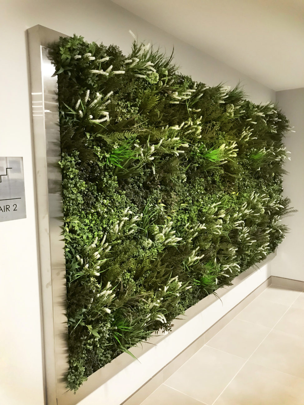 Artificial foliage install in condo hallway